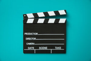 The vintage clapperboard on blue background. Top view
